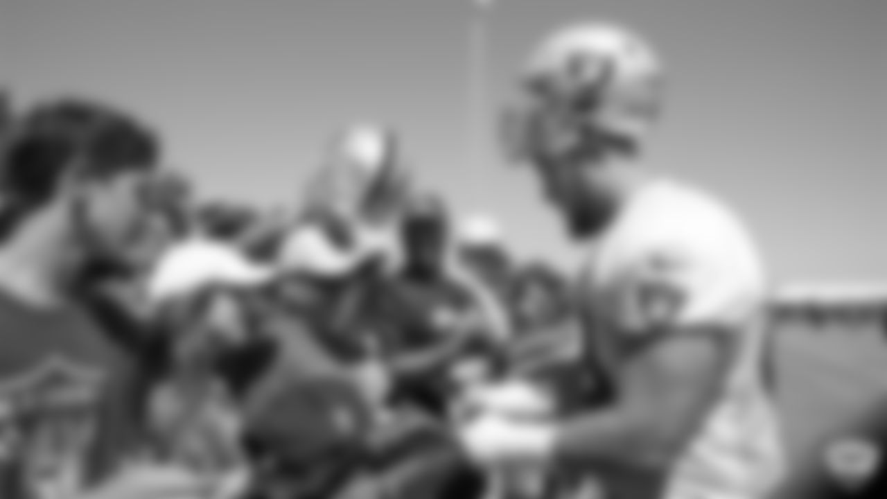 Raiders tackle Andre James (68) signs autographs for fans after practice at 2019 Training Camp.