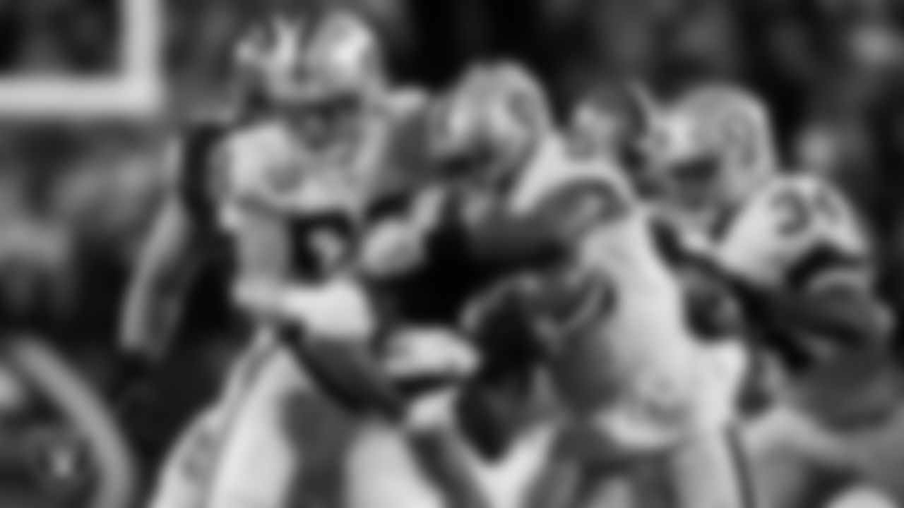 Las Vegas Raiders defensive end Maxx Crosby (98) and linebacker Marquel Lee (55) make a tackle during the regular season away game against the Cleveland Browns.