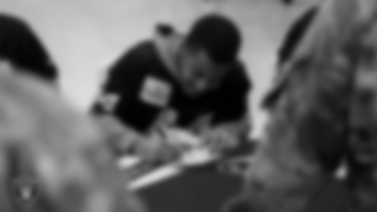 Las Vegas Raiders safety Bryce Cosby (44) signs autographs for Air Force members from Creech Air Force Base.