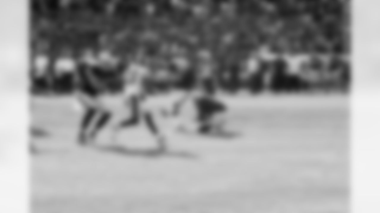 K Sebastian Janikowski kicks the game-winning field goal on the edge of the grass.