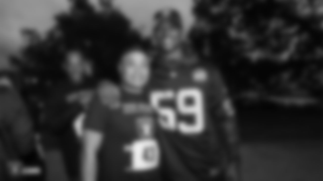 Raiders linebacker Tahir Whitehead (59) poses for a photo with a race participant at a Run Life's Course 5K run/walk and famous Grooves Dance Workout.