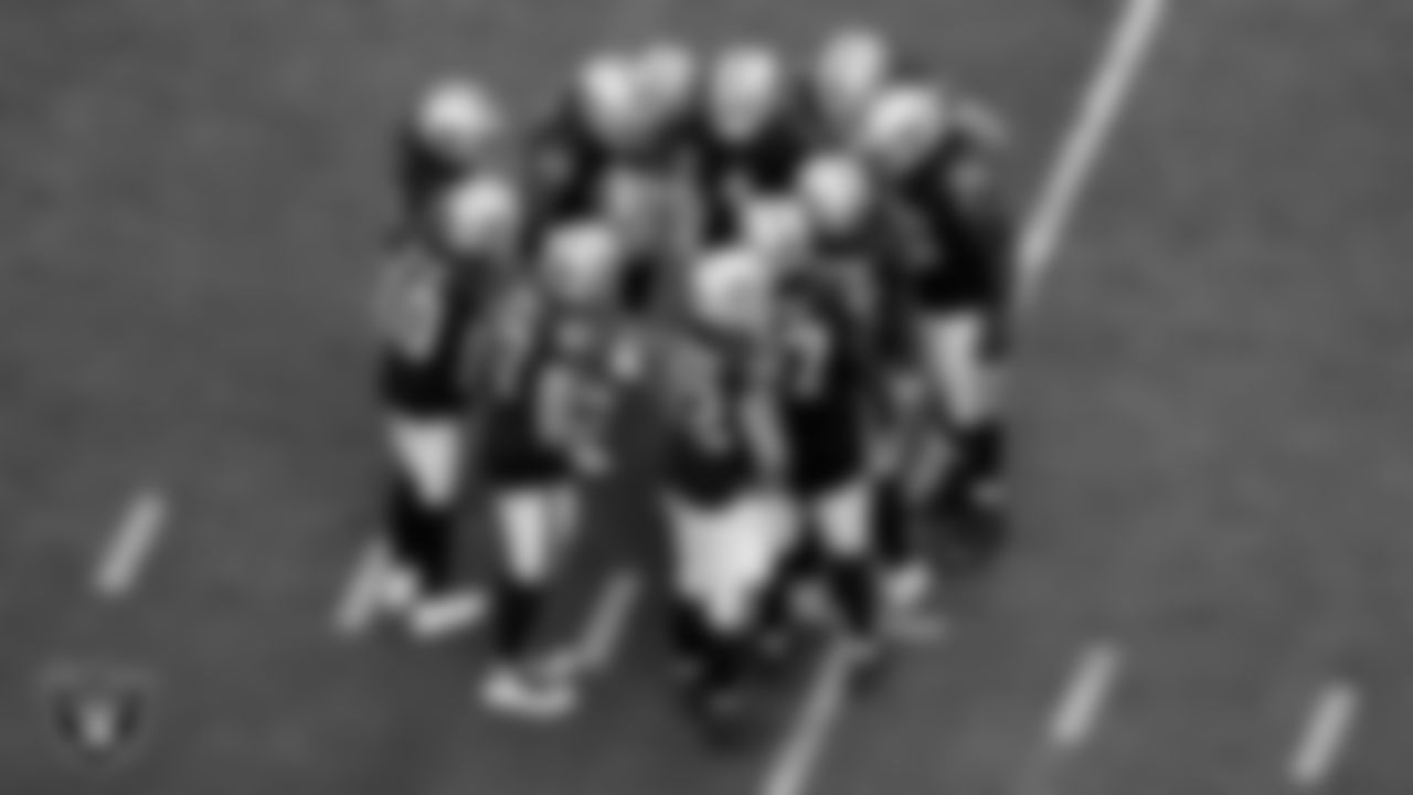 The Las Vegas Raiders offense huddle during the regular season home game against the Arizona Cardinals at Allegiant Stadium.