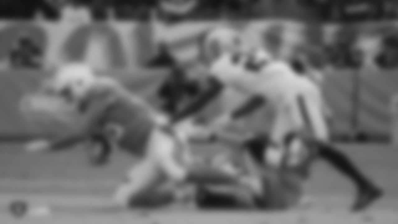 Raiders linebacker Will Compton (51) and cornerback Trayvon Mullen (27) make a tackle during the regular season game against the Los Angeles Chargers.