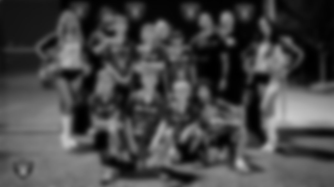 Raiderettes Camryn and Kelsey pose for a photo with athletes after an end of the season Silver and Black Flag Football League championship game at Teton Trails Park.