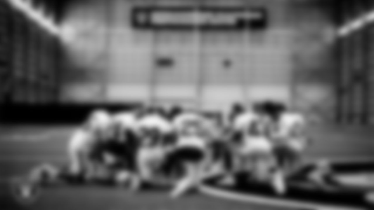 The Las Vegas Raiders defensive backs huddle during practice.