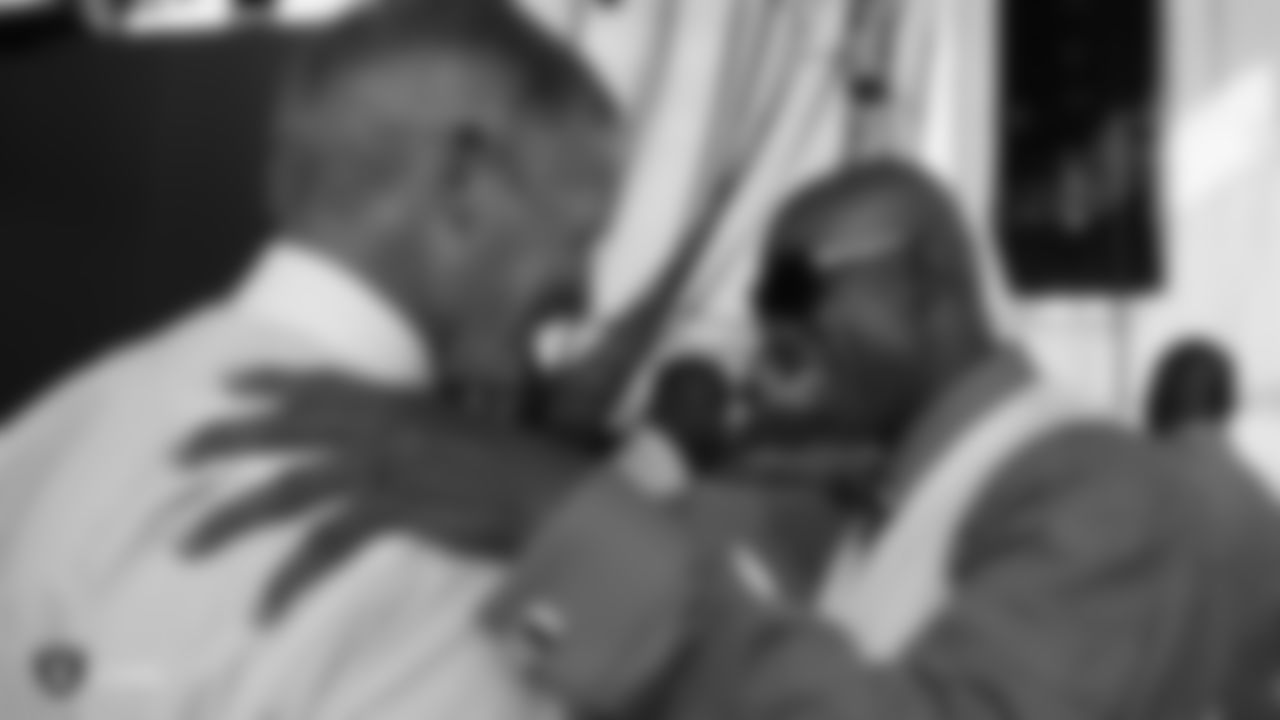 Hall of Fame enshrinee Deion Sanders (right) is greeted backstage by NFL Network analyst Mike Mayock before the 2011 Football Hall of Fame ceremony in Canton, Ohio on August 6, 2011.