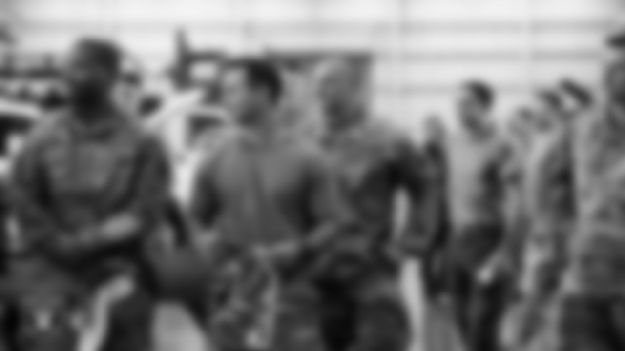 Service members listen to Las Vegas Raiders alumnus, Roy Hart, during Operation Donut Drop at Nellis Air Force Base.