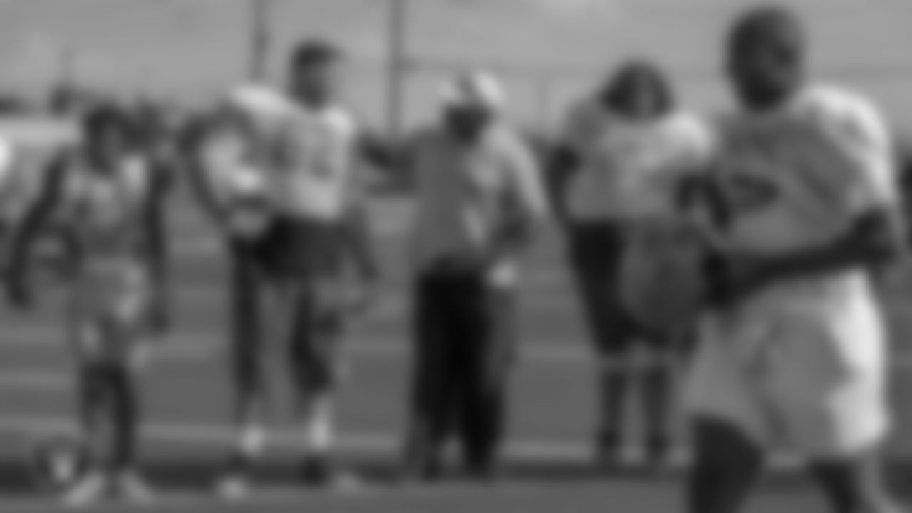Las Vegas Raiders alumnus Roy Hart talks to a Mojave High School football player.