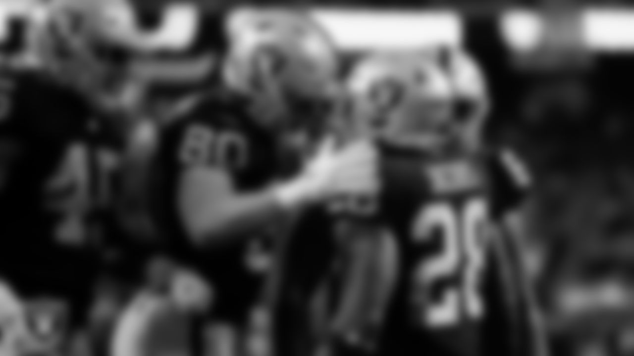 Las Vegas Raiders running back Josh Jacobs (28) is congratulated by tight end Jesper Horsted (80) after rushing for a 1-yard touchdown during the regular season home game against the Indianapolis Colts at Allegiant Stadium.