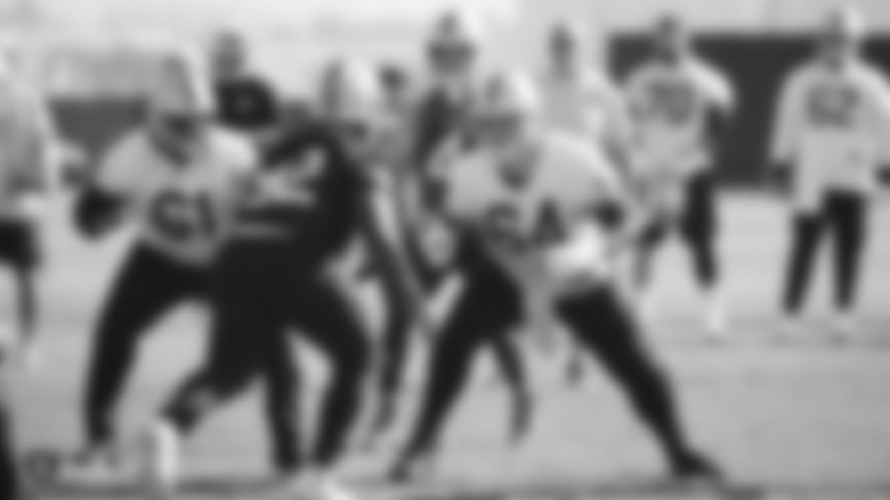 Raiders center Rodney Hudson (61) and guard Richie Incognito (64) block for quarterback Derek Carr (4) during practice.