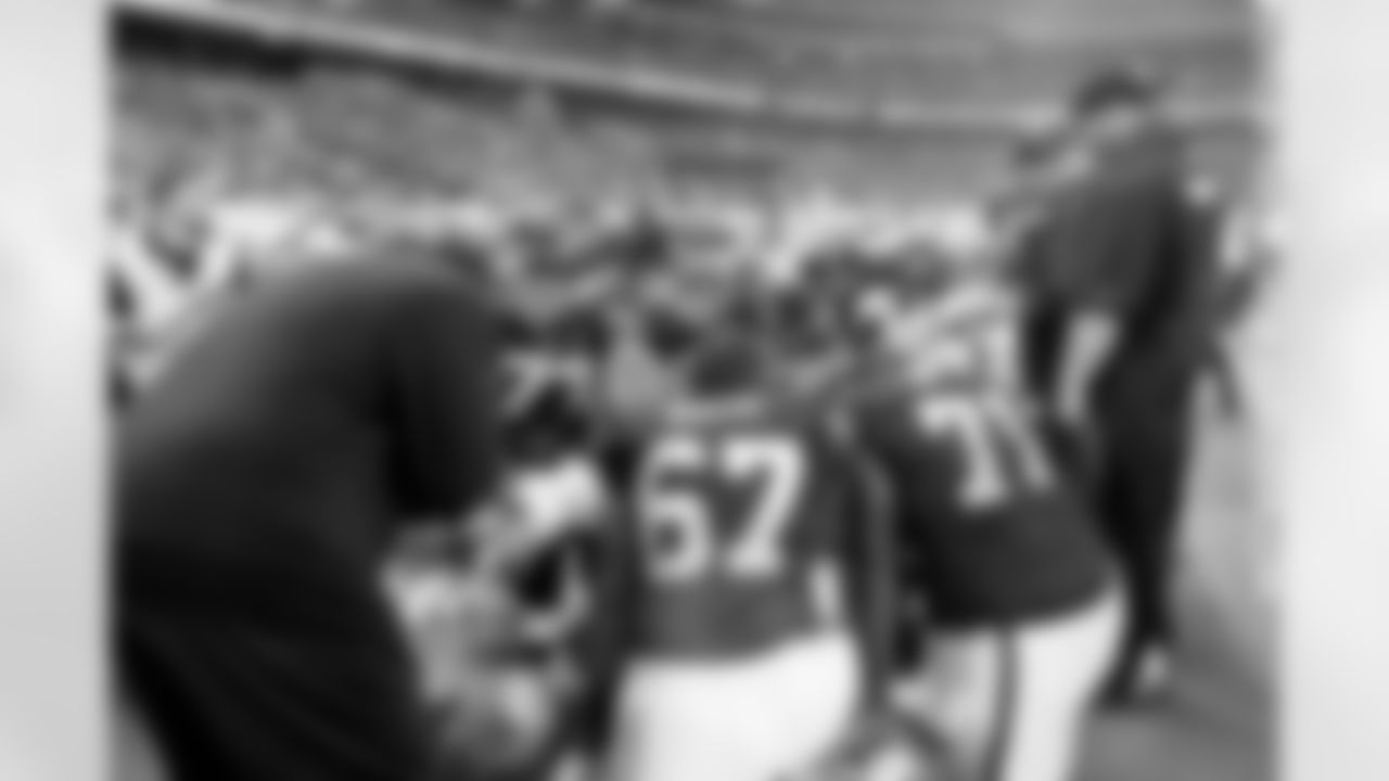 The offensive line huddles on the sideline with O-line coach Tony Sparano.
