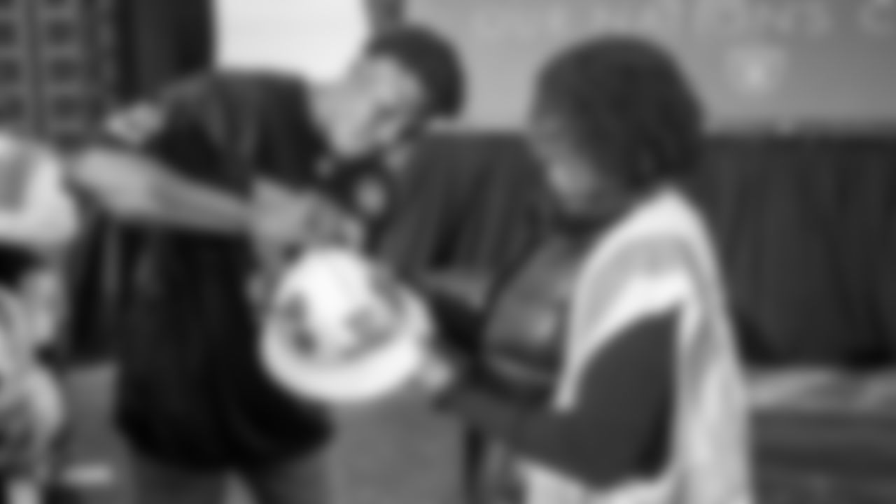 Raiders linebacker Marquel Lee (52) signs an autograph for a construction worker following an official announcement of the Raiders changing their name to the Las Vegas Raiders.