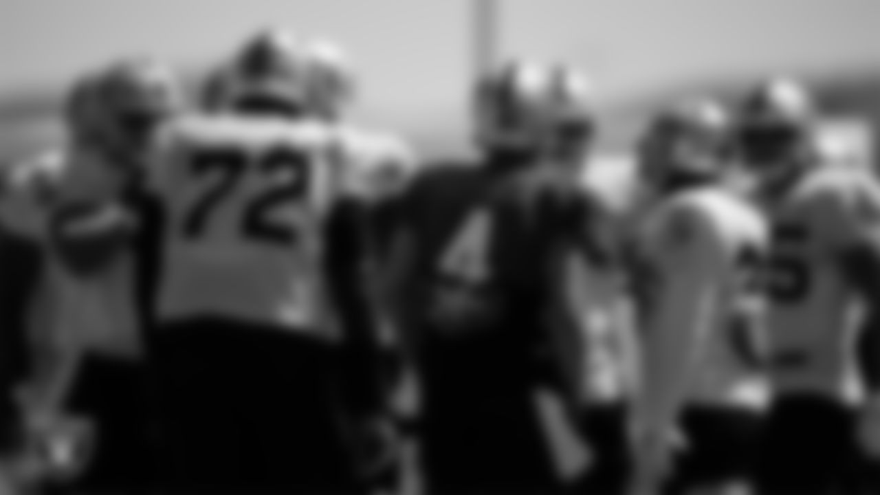 The Las Vegas Raiders offense huddles on the field for practice at 2021 Training Camp.