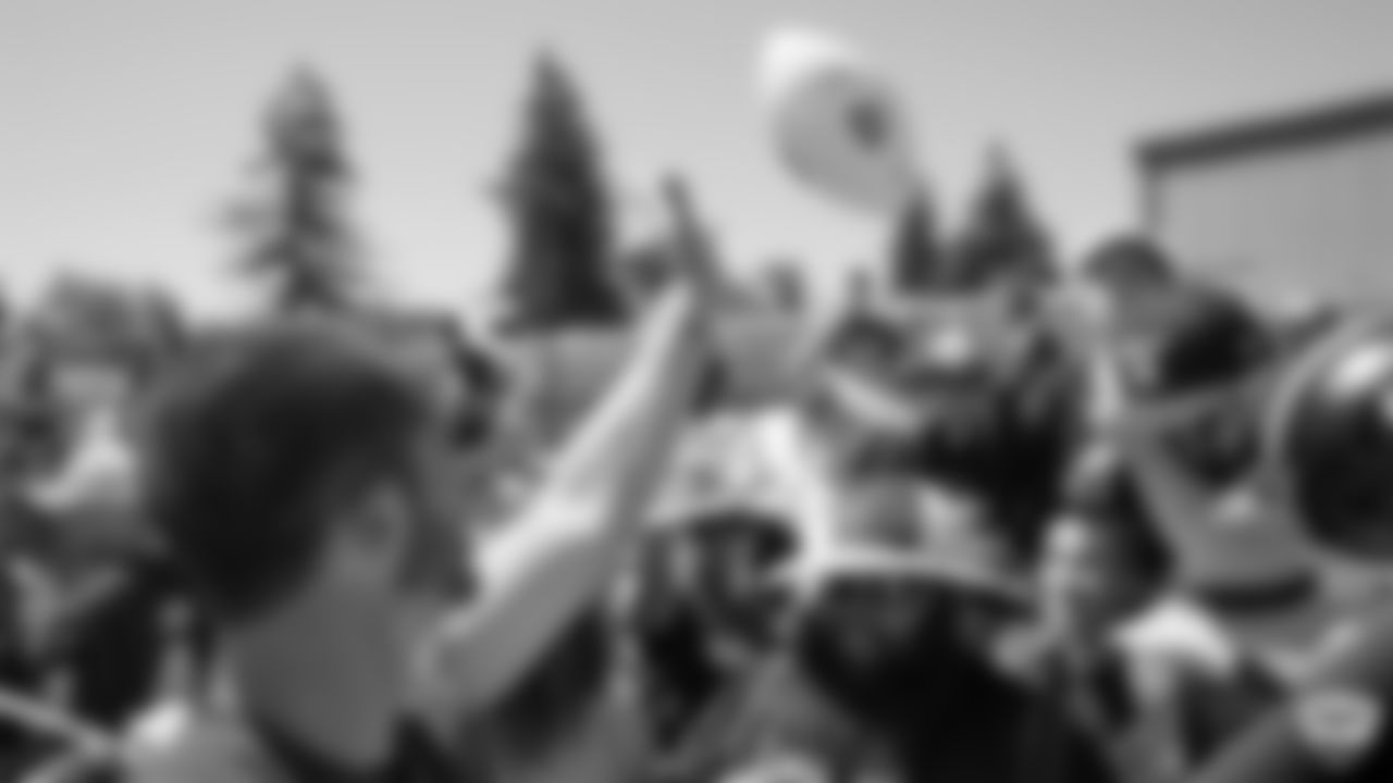 Oakland Raiders quarterback Derek Carr (4) signs autographs for fans after practice at 2019 Training Camp.