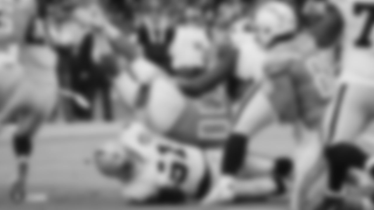Raiders linebacker Will Compton (51) and defensive tackle P.J. Hall (92) make a tackle during the regular season game against the Los Angeles Chargers.