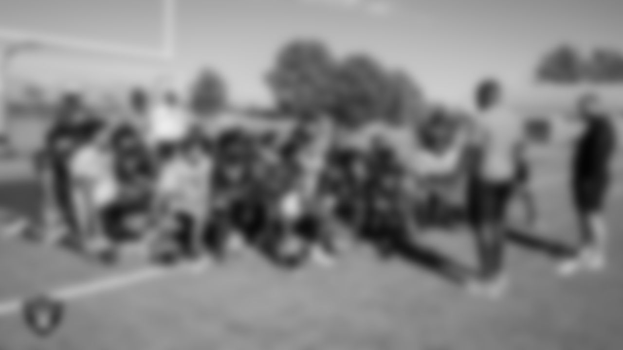 Las Vegas Raiders offensive lineman Jordan Meredith (61) and linebacker Malik Reed (52) speak to the Cheyanne High School football team before their practice at Cheyanne High School.