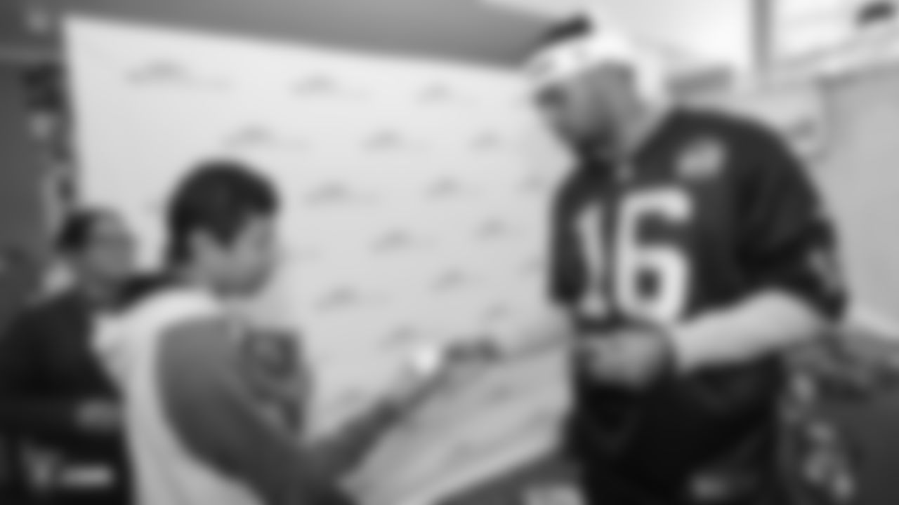 Raiders wide receiver Tyrell Williams (16) hands out Raiders souvenirs to a kid during a visit to UCSF Benioff Children's Hospital Oakland.