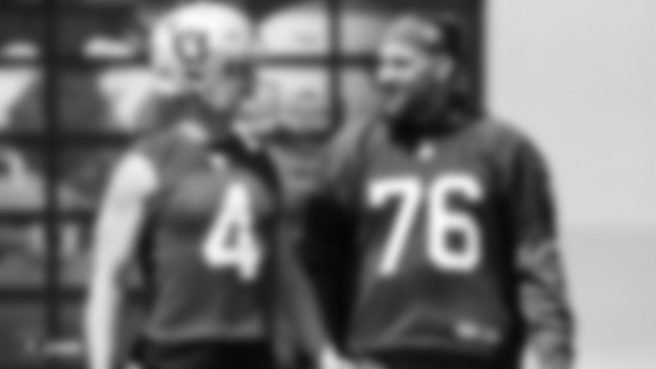 Oakland Raiders quarterback Derek Carr (4) and offensive guard Jon Feliciano (76) on the field for practice at the Oakland Raiders Practice Facility, Thursday, September 6, 2018, in Alameda, California.