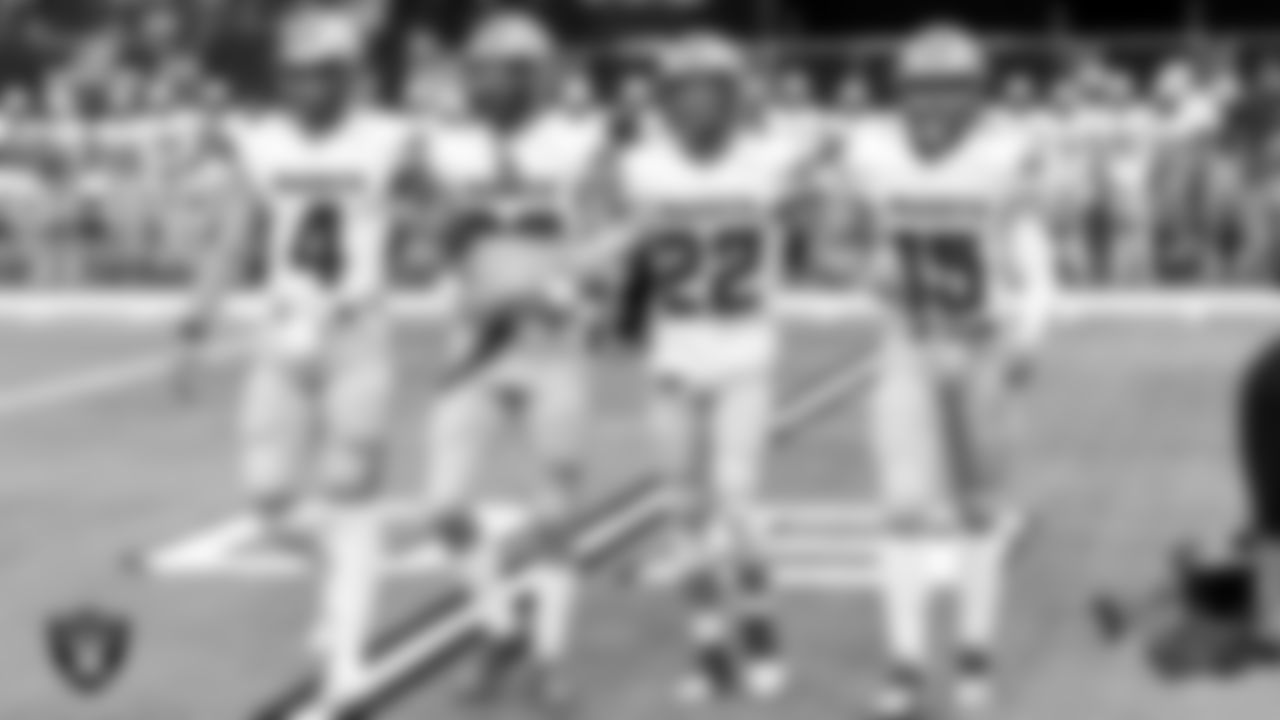 Team captains from Robert McQueen High School head to centerfield for the coin toss before their game against Bishop Gorman High School during the NIAA Class 5A State Football Championship at Allegiant Stadium.