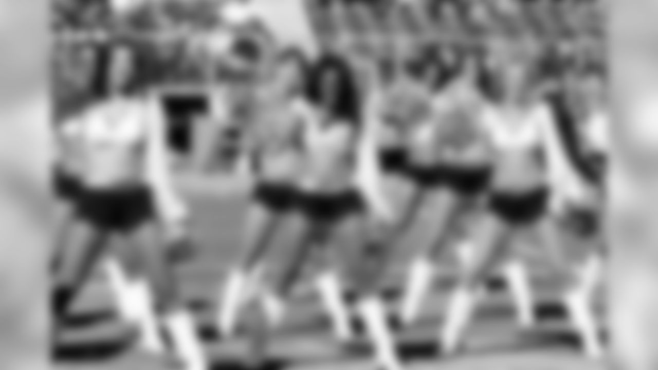 Raiderettes Mallorie, Voz, and Anna perform in the front row during pregame.