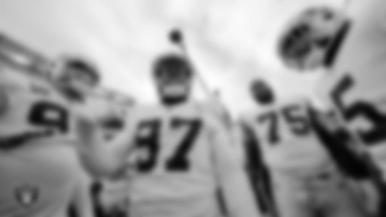 Las Vegas Raiders defensive tackle Damion Square (97) fires the team up in a huddle during warm ups before the postseason away game against the Cincinnati Bengals.