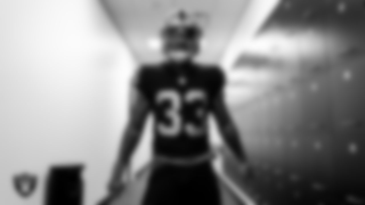 Las Vegas Raiders running back Lynn Bowden Jr. (33) tries on his helmet, jersey and pads after arriving for 2020 Training Camp.