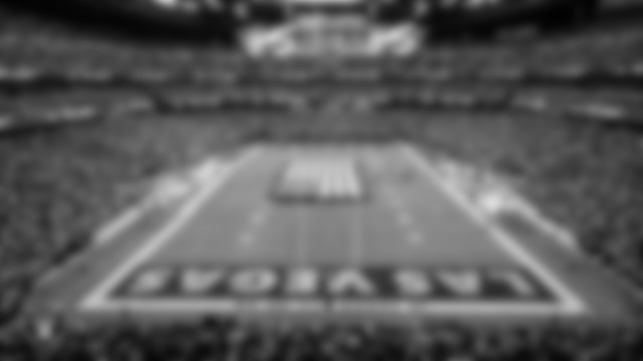 The American flag is displayed by Personal Seat License (PSL) holders on the field during the national anthem before the Las Vegas Raiders' regular season home game against the Denver Broncos at Allegiant Stadium.