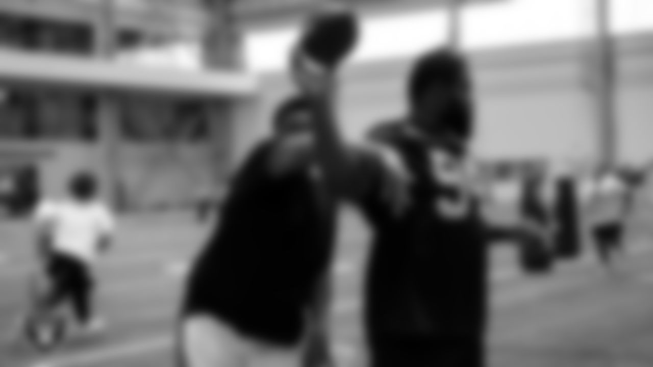 Las Vegas Raiders defensive tackle Matthew Butler (94) works with an athlete as they participate in drills during the ELITE Academy at Las Vegas Raiders Headquarters.