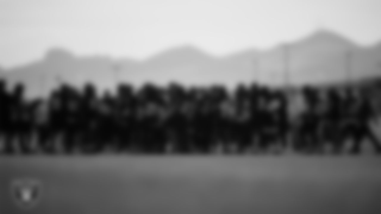 Las Vegas Raiders players and coaches huddle during phase two of the offseason program at Intermountain Health Performance Center.