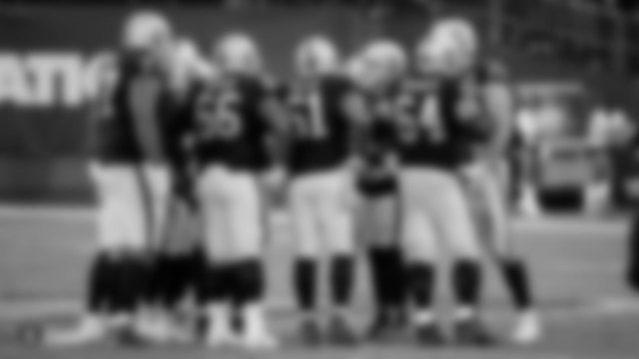 The Raiders huddle during the regular season game against the Cincinnati Bengals at the Oakland-Alameda County Coliseum.