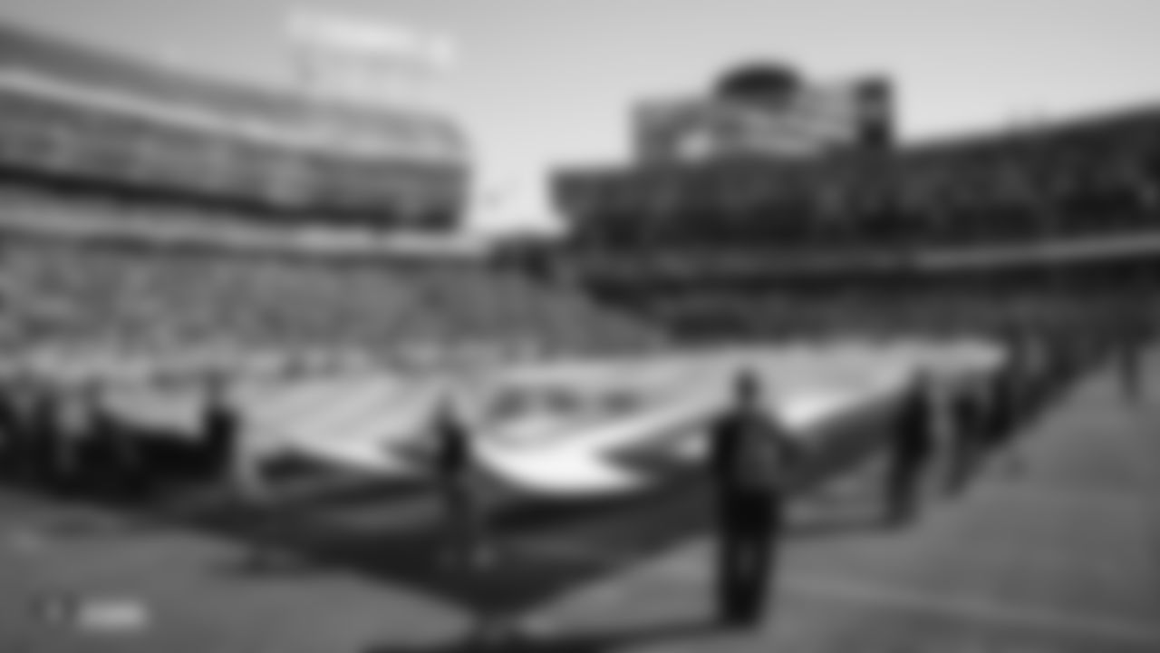 The American flag is displayed by season ticket members on the field during the national anthem before the Raiders regular season game against the Detroit Lions.