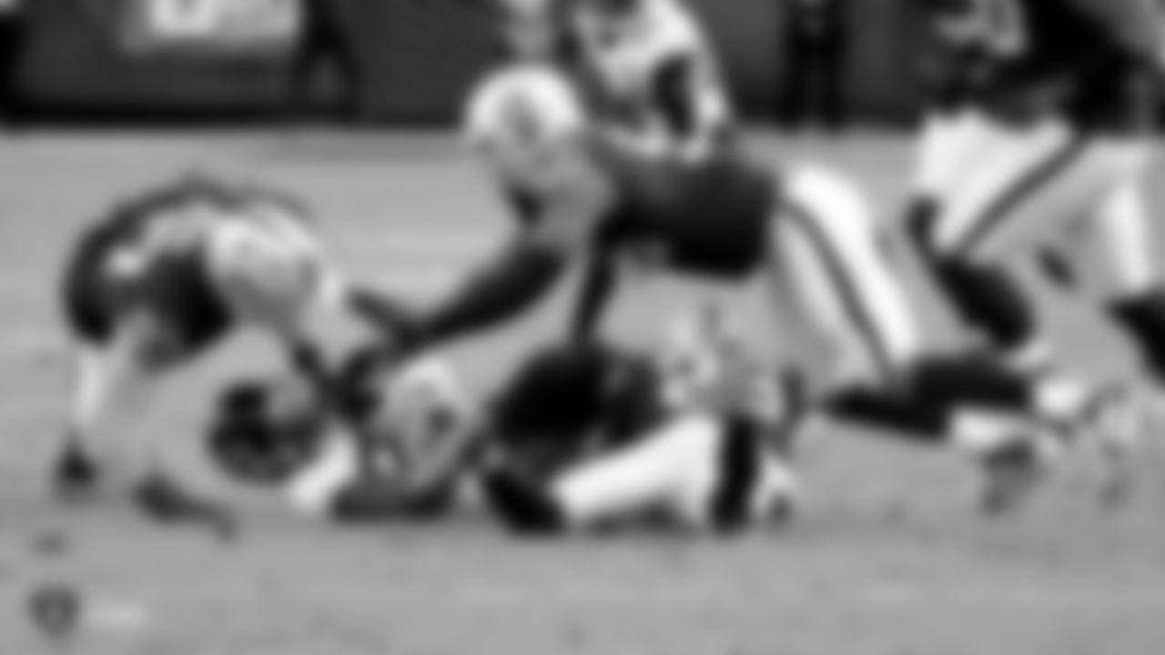 Raiders defensive end Josh Mauro (97), defensive end Clelin Ferrell (96) and cornerback Nevin Lawson (26) make a tackle during the regular season game against the Jacksonville Jaguars.
