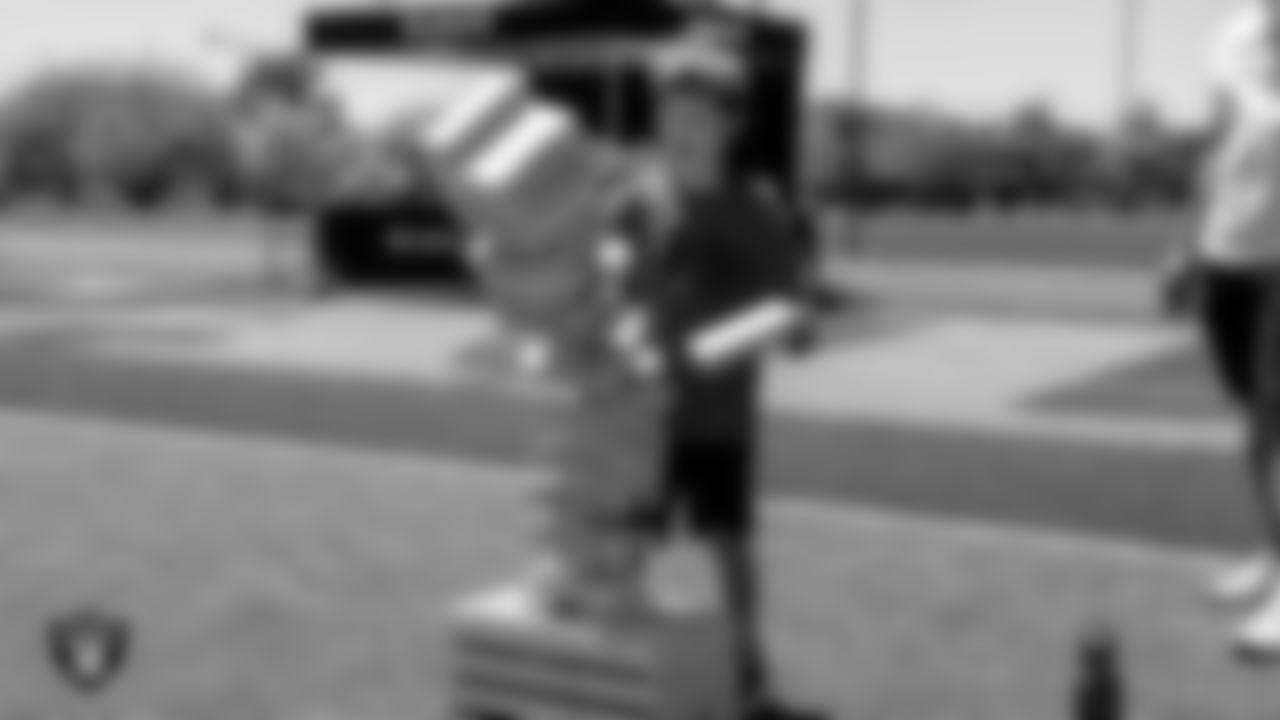 A youth football player watches as the Jenga tower falls over during the USA Football Summer Blitz.