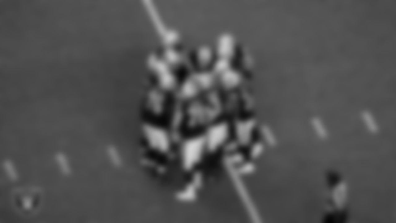 The Las Vegas Raiders offense huddles during the preseason home game against the New England Patriots at Allegiant Stadium.