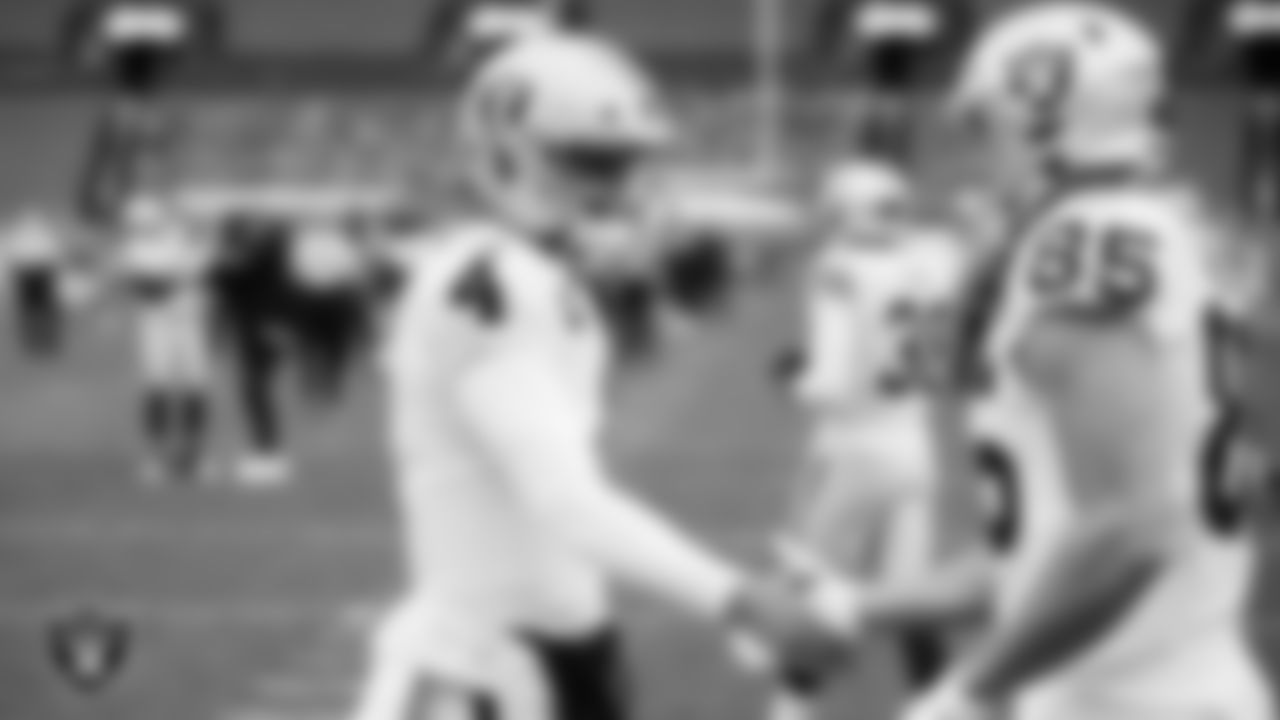Las Vegas Raiders quarterback Derek Carr (4) and tight end Derek Carrier (85) warming up before the regular season away game against the Denver Broncos.