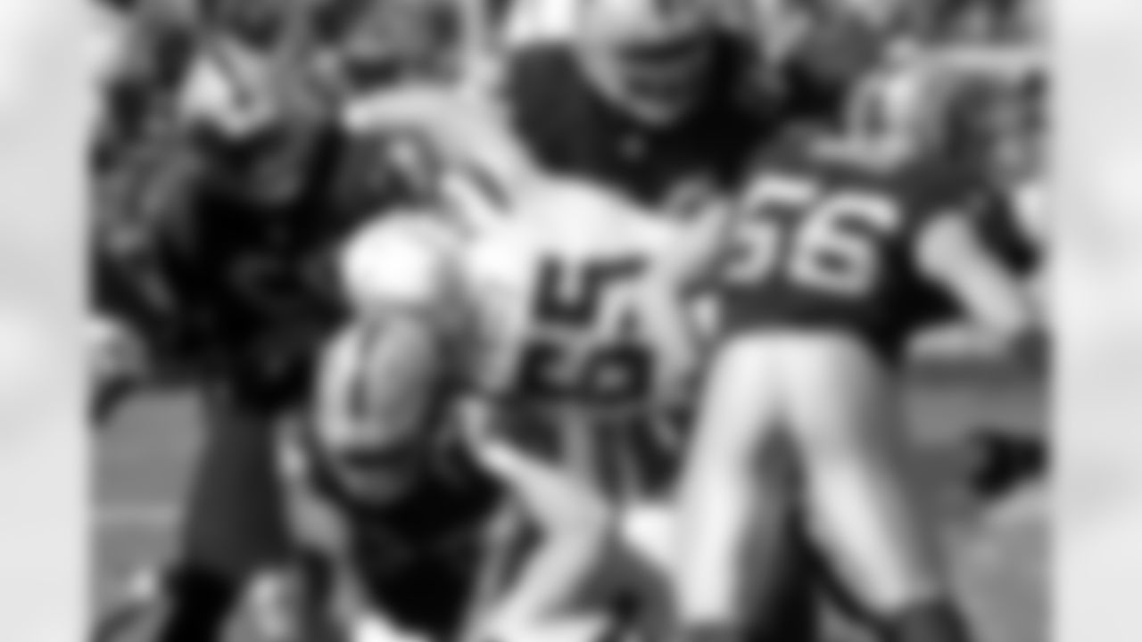 The Raiders defense swarms the ball carrier.