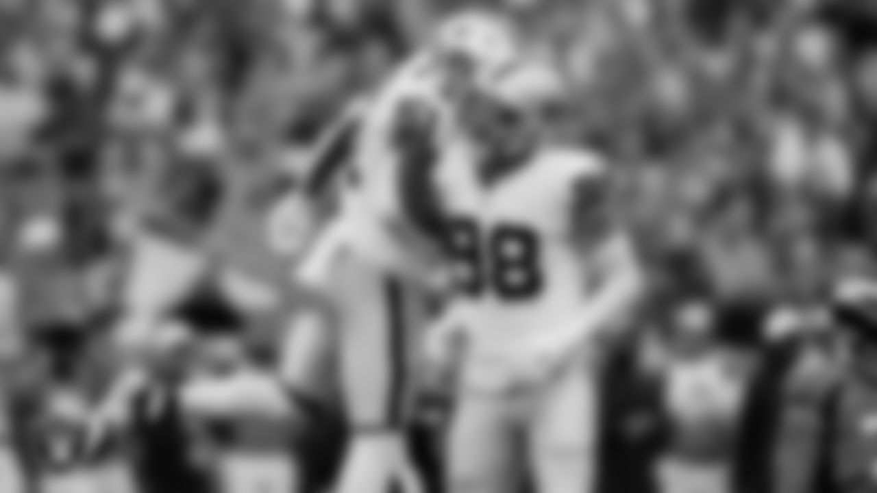 Las Vegas Raiders defensive end Malcolm Koonce (51) and defensive end Maxx Crosby (98) celebrate after sacking the quarterback during the regular season away game against the Denver Broncos at Empower Field at Mile High.