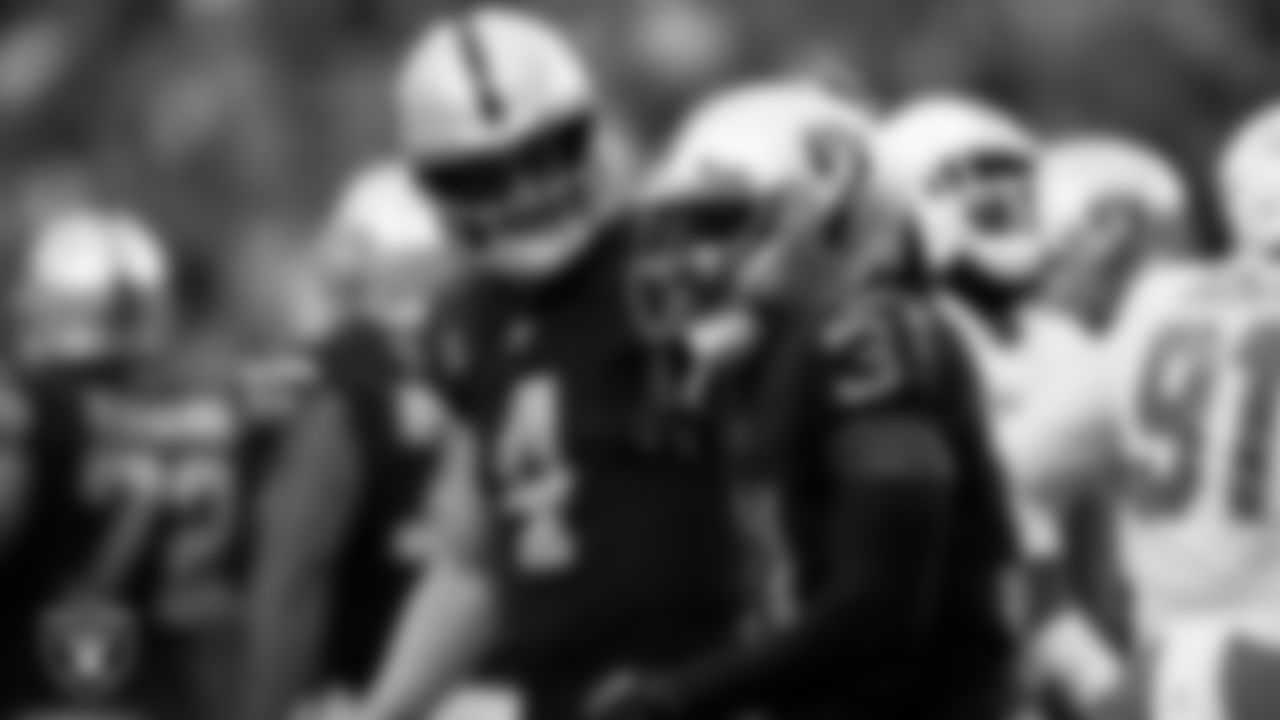 Las Vegas Raiders running back Peyton Barber (31) is congratulated by quarterback Derek Carr (4) after rushing for a 1-yard touchdown during the regular season home game against the Miami Dolphins.