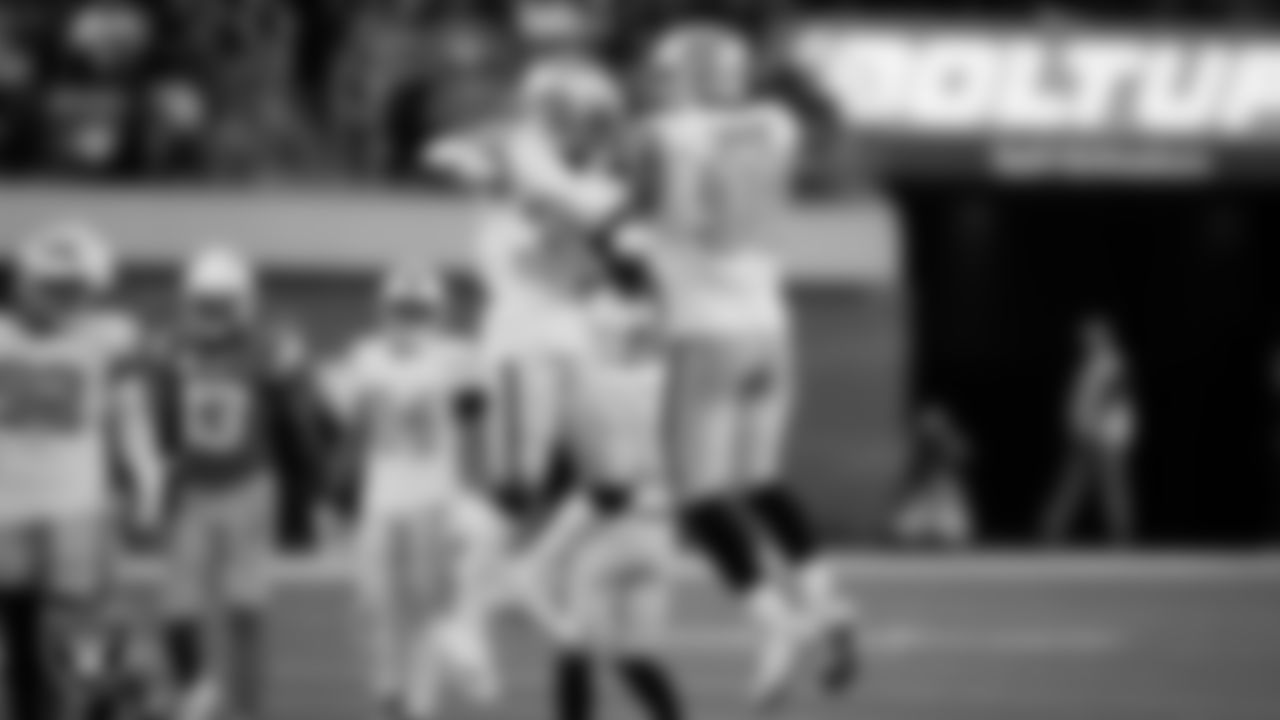 Las Vegas Raiders cornerback Nate Hobbs (39) and defensive end Maxx Crosby (98) celebrate after breaking up a pass during the regular season away game against the Los Angeles Chargers.