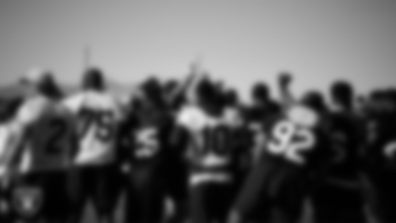 The Las Vegas Raiders huddle at a workout during phase two of the offseason program.