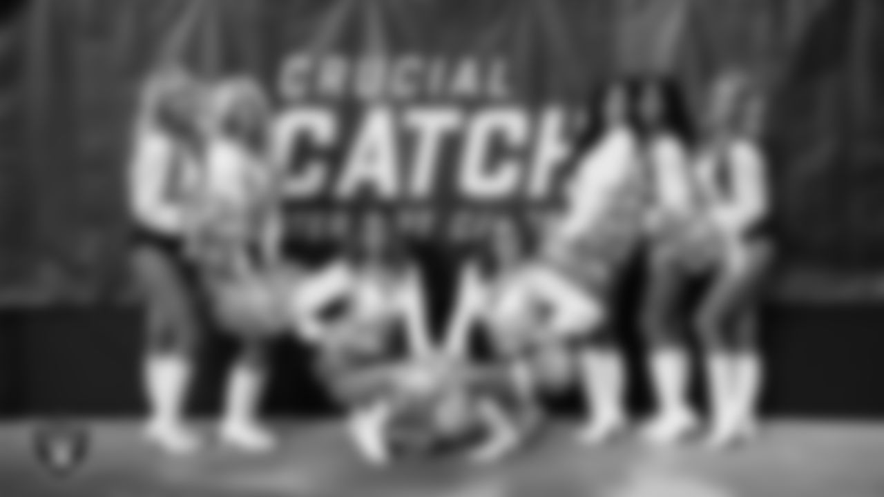 Raiderettes Kelly, Camryn, Maddie, Mackenzie, Nicola, Monet and Nicole pose for a photo in front of a Crucial Catch sign on the sidelines during the regular season home game against the Chicago Bears.