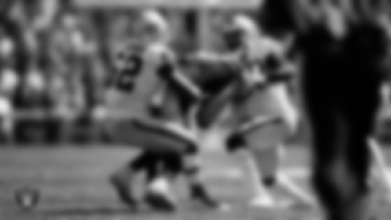 Las Vegas Raiders linebacker Denzel Perryman (52) and cornerback Nate Hobbs (39) make a tackle during the regular season away game against the Pittsburgh Steelers.