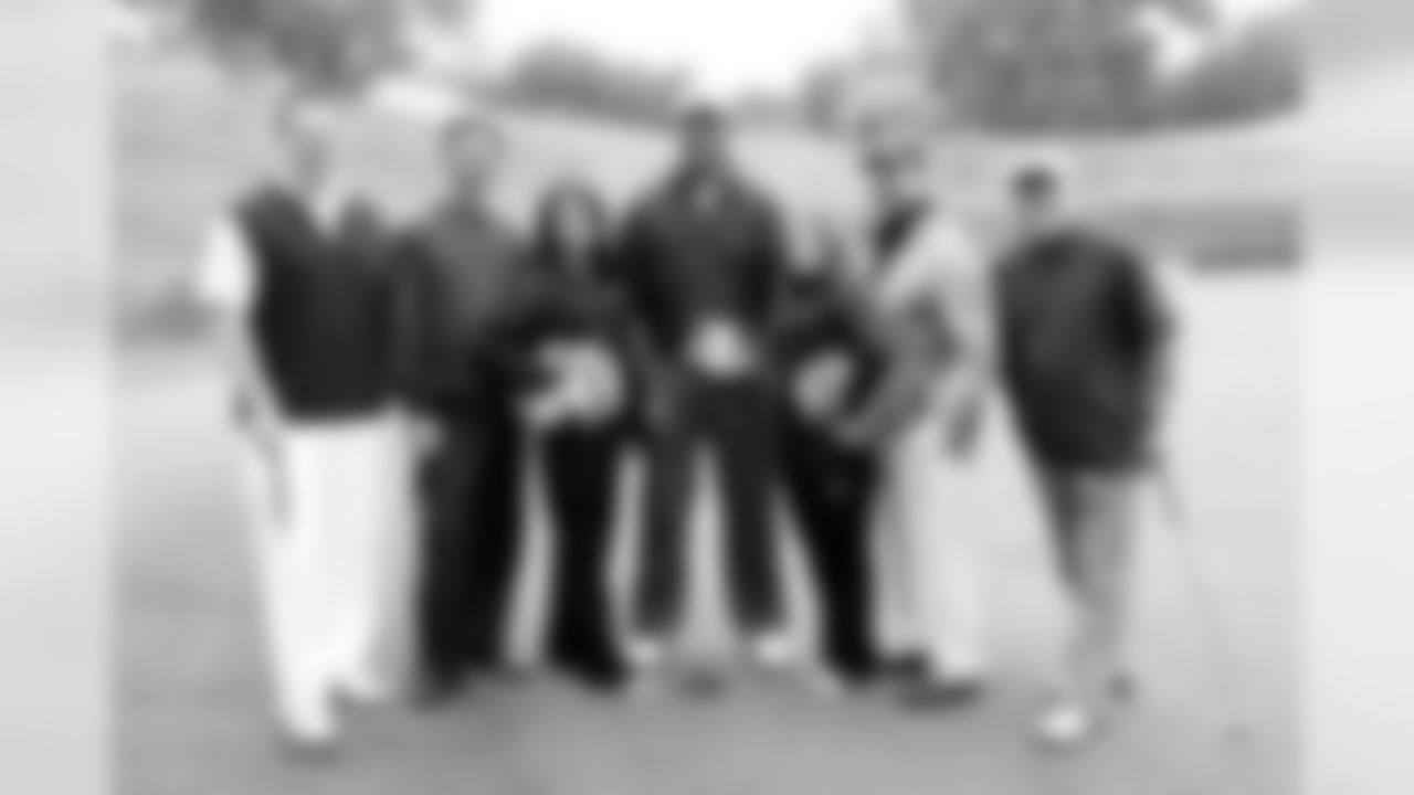 Hall of Famer Mike Haynes, his foursome and Raiderettes Sarah Marie and Alli pose for a photo.
