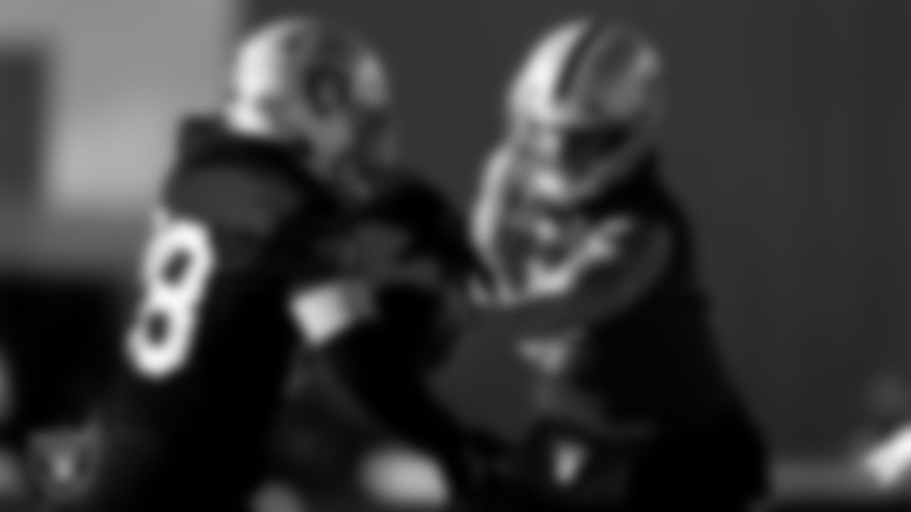 Las Vegas Raiders running back Josh Jacobs (28) and quarterback Derek Carr (4) during practice at Intermountain Healthcare Performance Center.