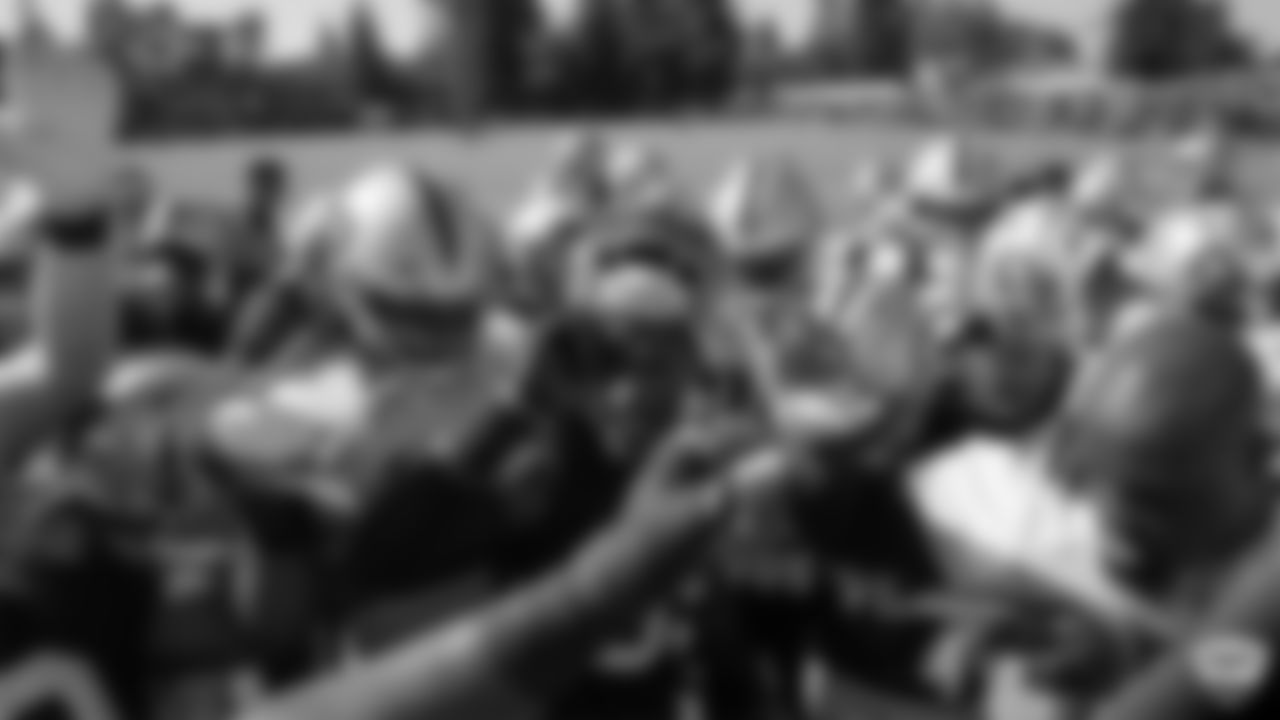 The Oakland Raiders huddle up on the field for practice at 2019 Training Camp.