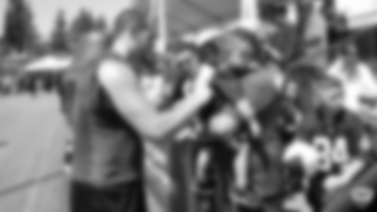 Raiders quarterback Derek Carr (4) signs autographs for fans after practice at 2019 Training Camp.
