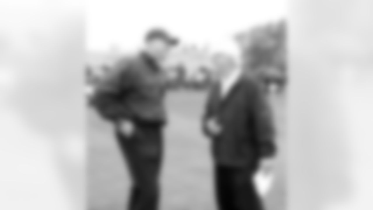 Defensive line coach Mike Waufle catches up with Fred Biletnikoff.