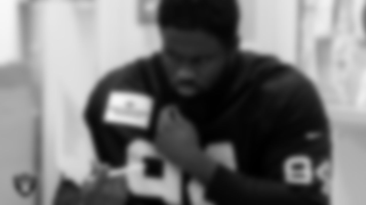 Las Vegas Raiders defensive tackle Matthew Butler (94) looks over song lyrics during the Hip Hop Entrepreneurship class.