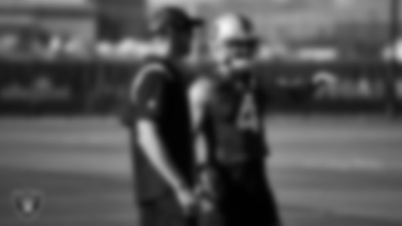 Las Vegas Raiders quarterbacks coach Bo Hardegree and quarterback Derek Carr (4) on the field for practice at 2022 Training Camp at Intermountain Healthcare Performance Center.