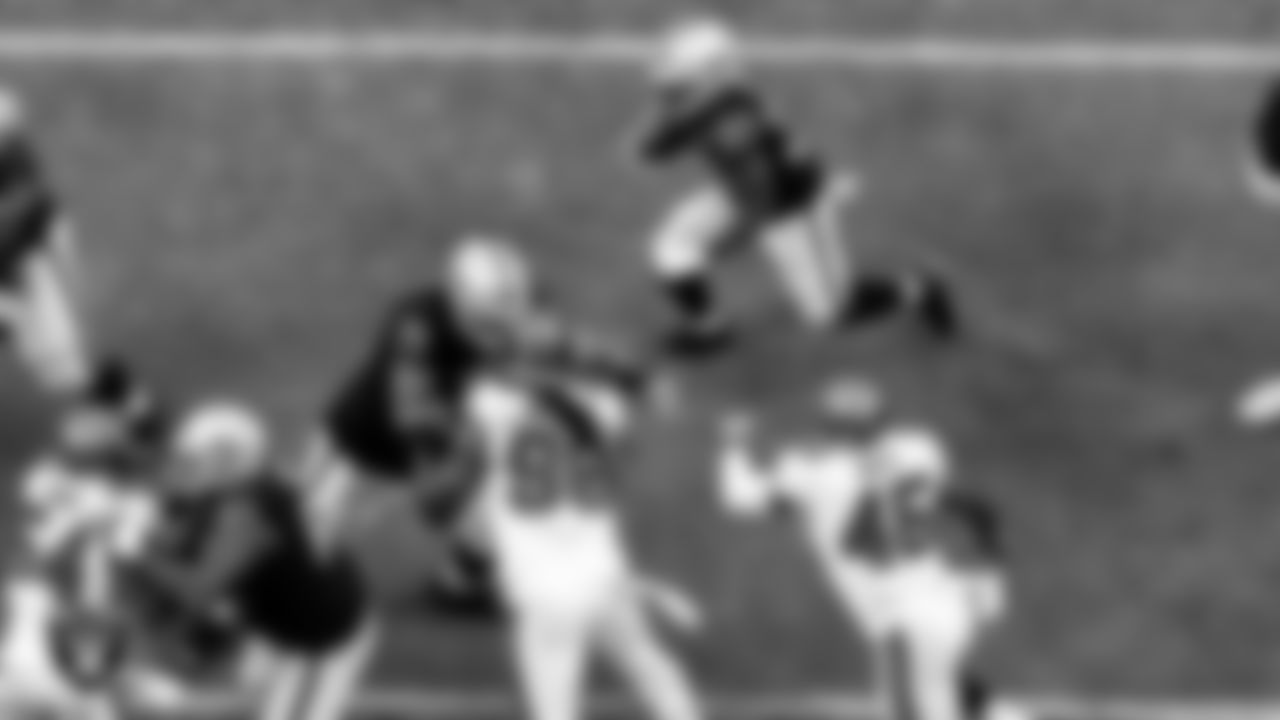 Las Vegas Raiders center Rodney Hudson (61) and tackle Denzelle Good (71) block as running back Jalen Richard (30) rushes during the regular season home game against the Tampa Bay Buccaneers.